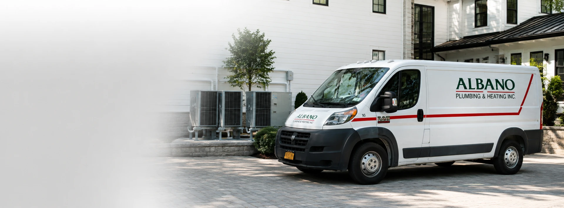 Albano Plumbing & Heating service van parked at a residential job site